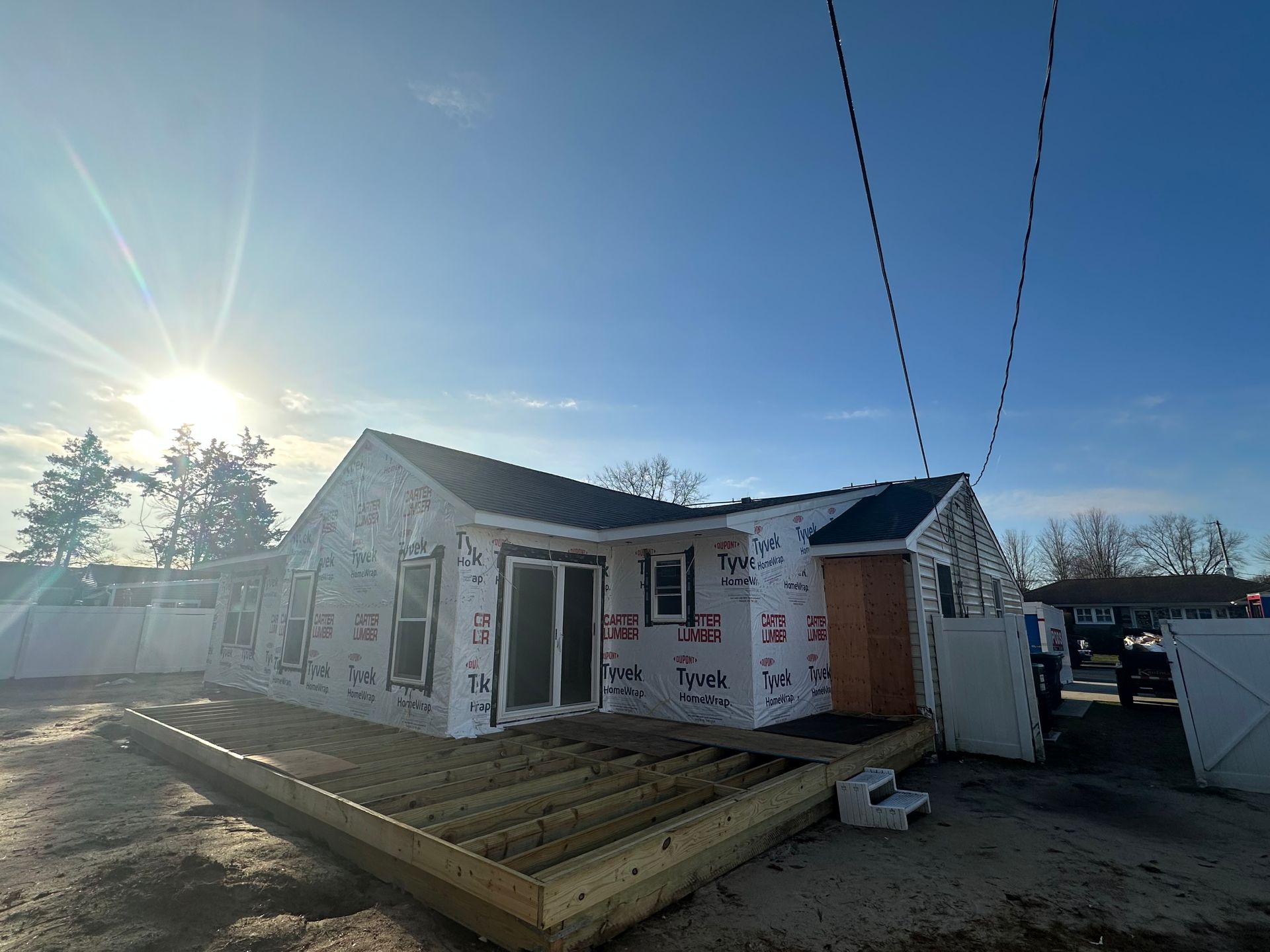 A house is being built with a wooden deck in front of it.