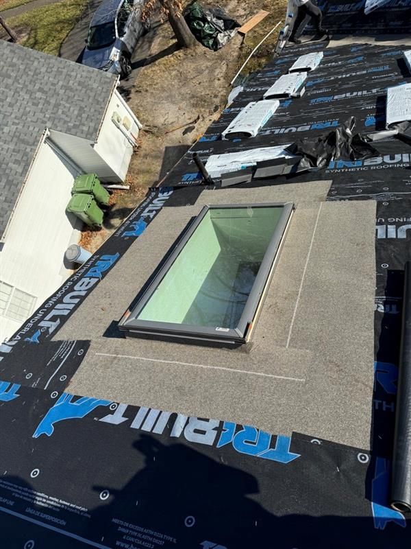 A skylight is being installed on the roof of a house.