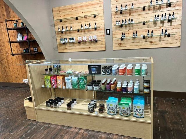 Retail display case with shelves of vape products and accessories in a store interior