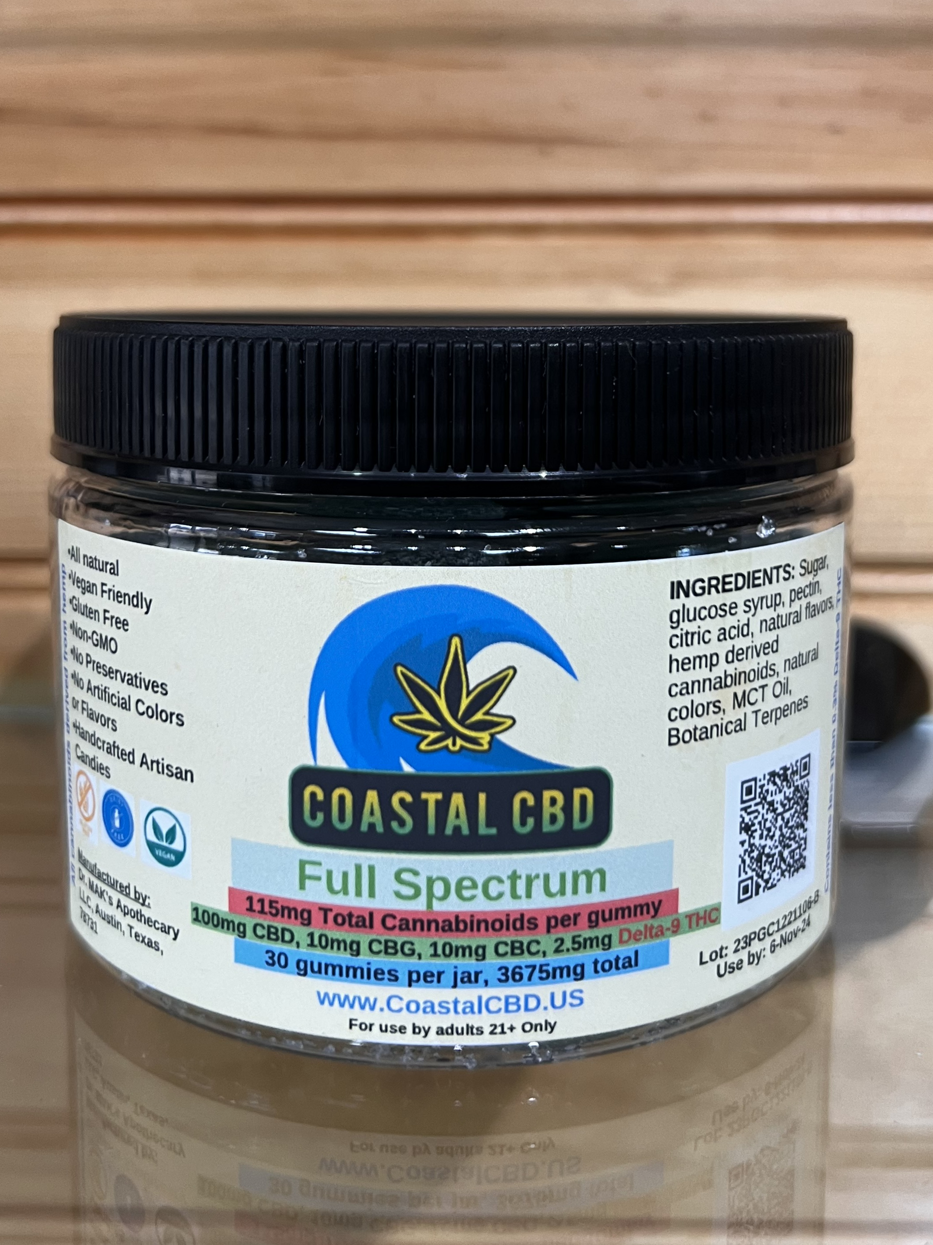 Coastal CBD Full Spectrum jar with black lid and white label on a wooden surface