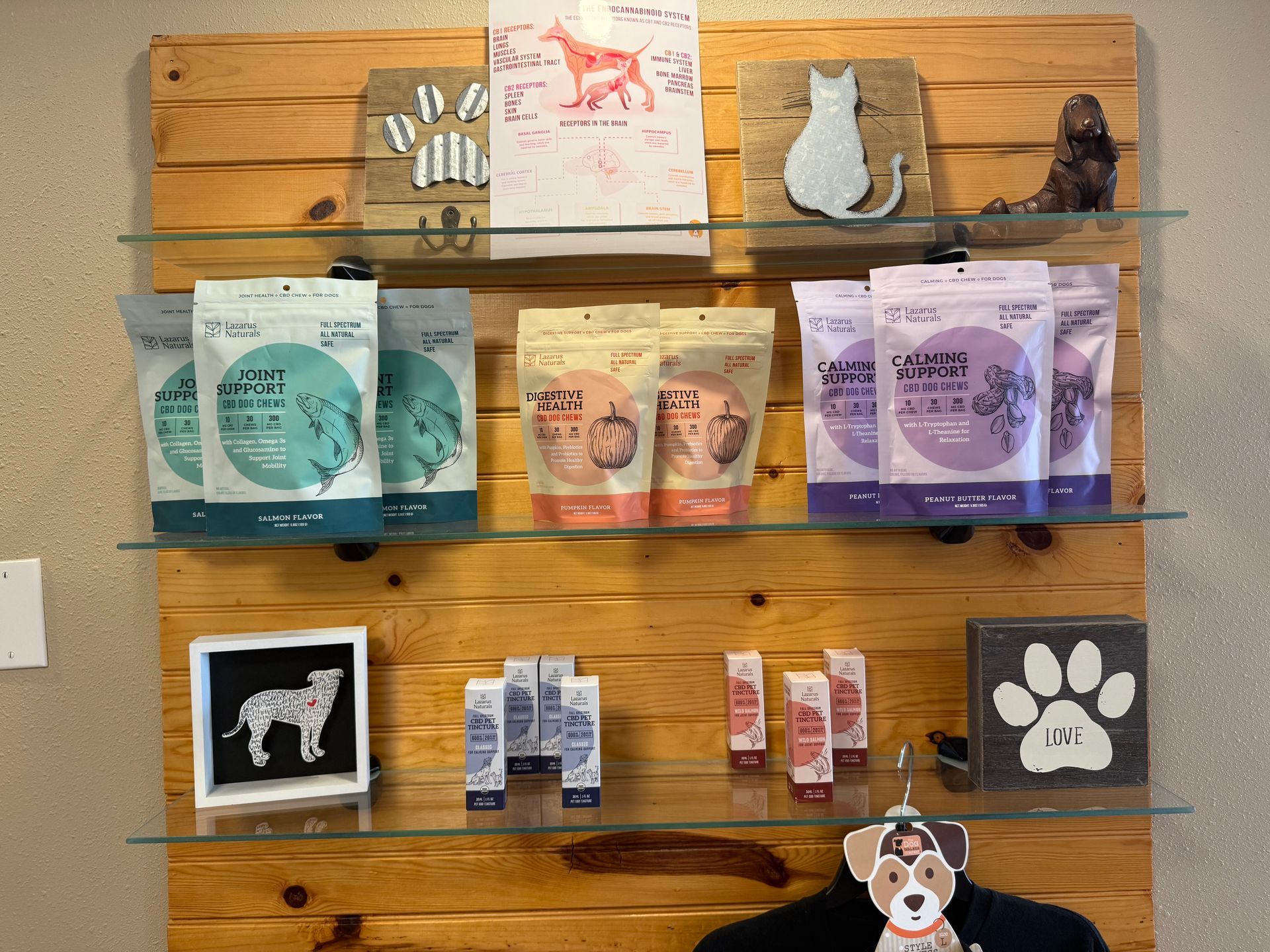 Products displayed on glass shelves against a wood wall