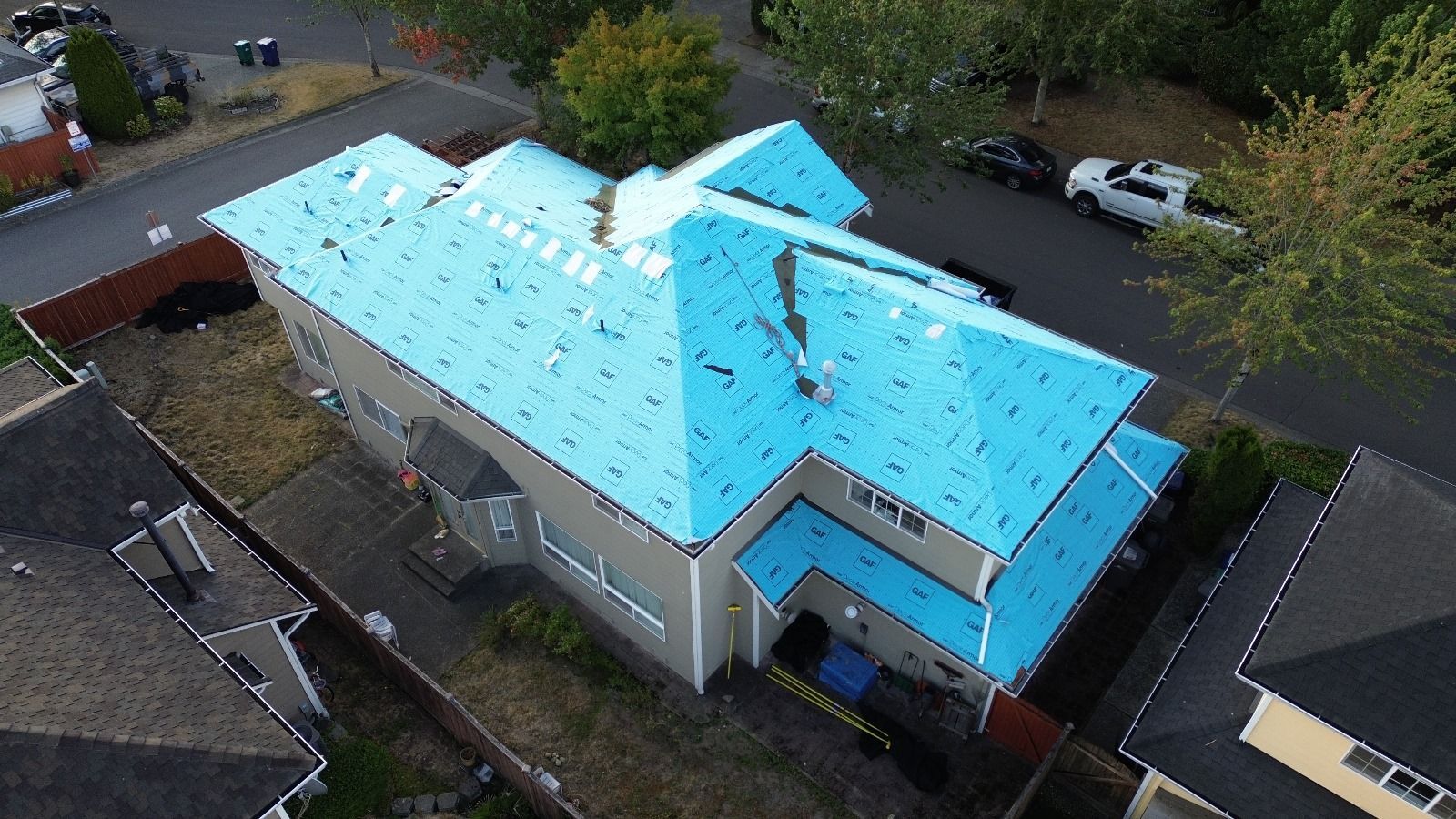 An aerial view of a house with a blue roof.