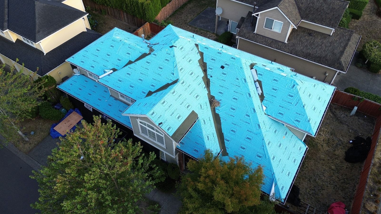 An aerial view of a house with a blue roof.