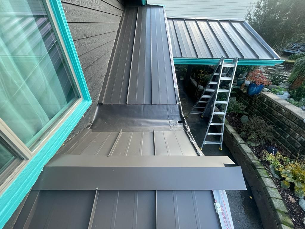 A ladder is sitting on the side of a house next to a window.