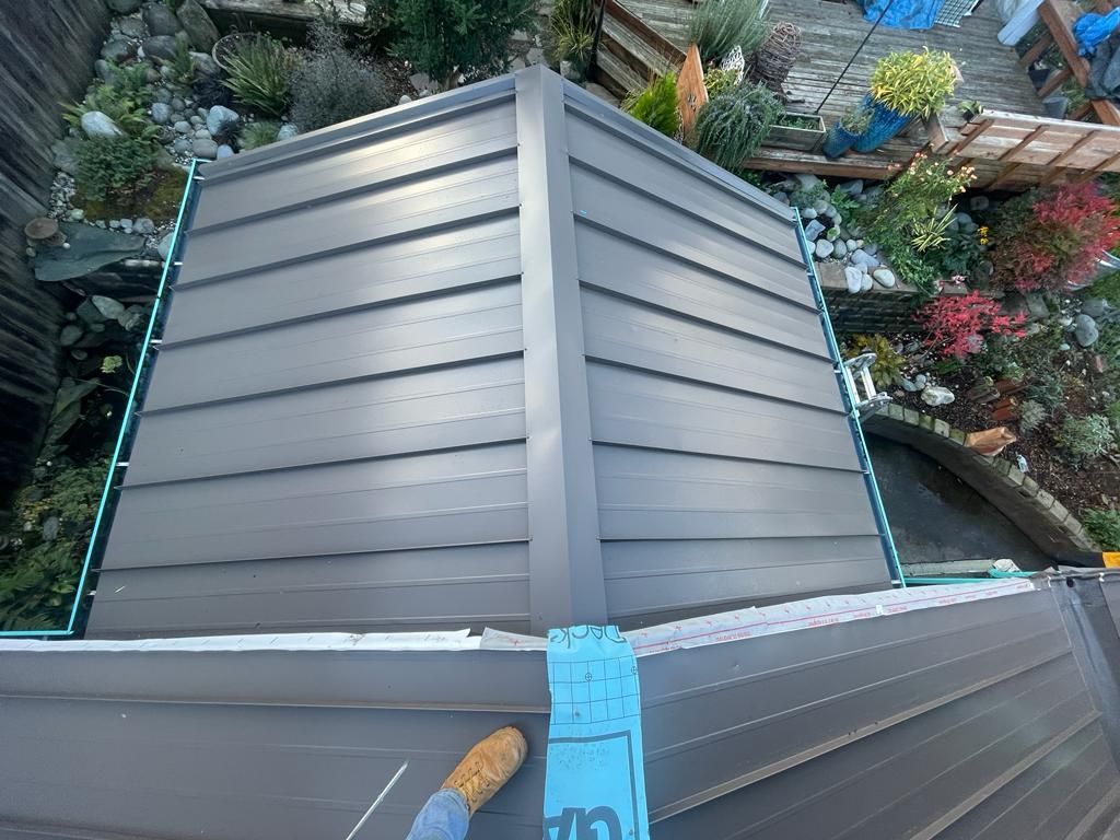 An aerial view of a roof with a blue tape on it.