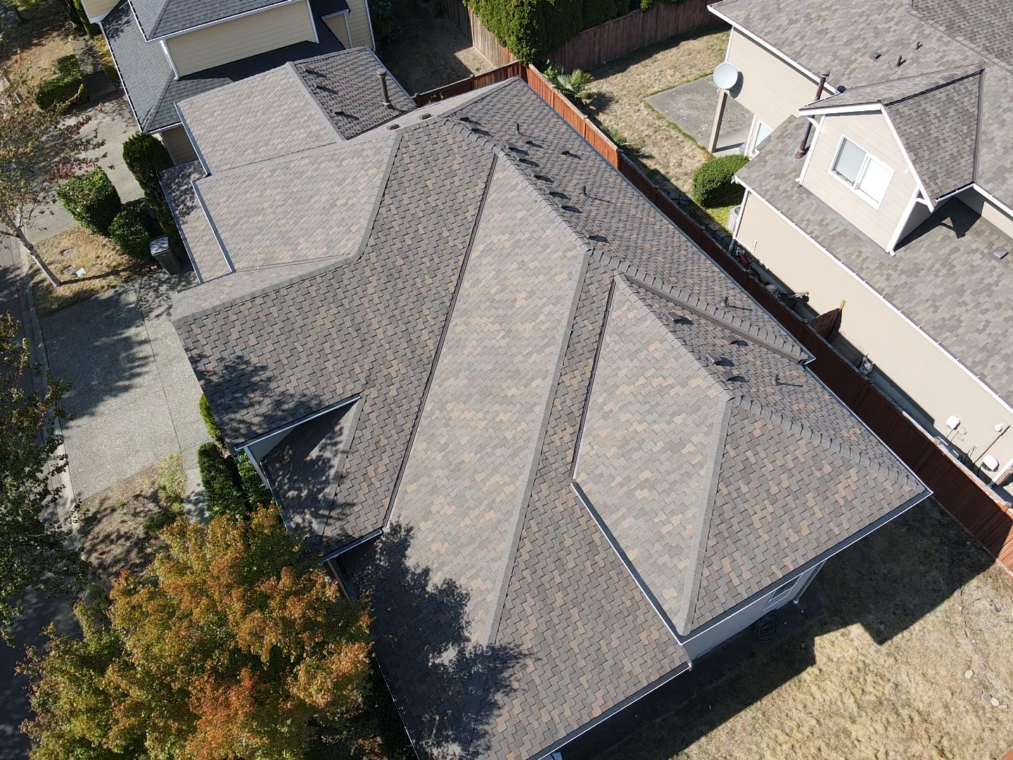 An aerial view of a roof of a house in a residential area.