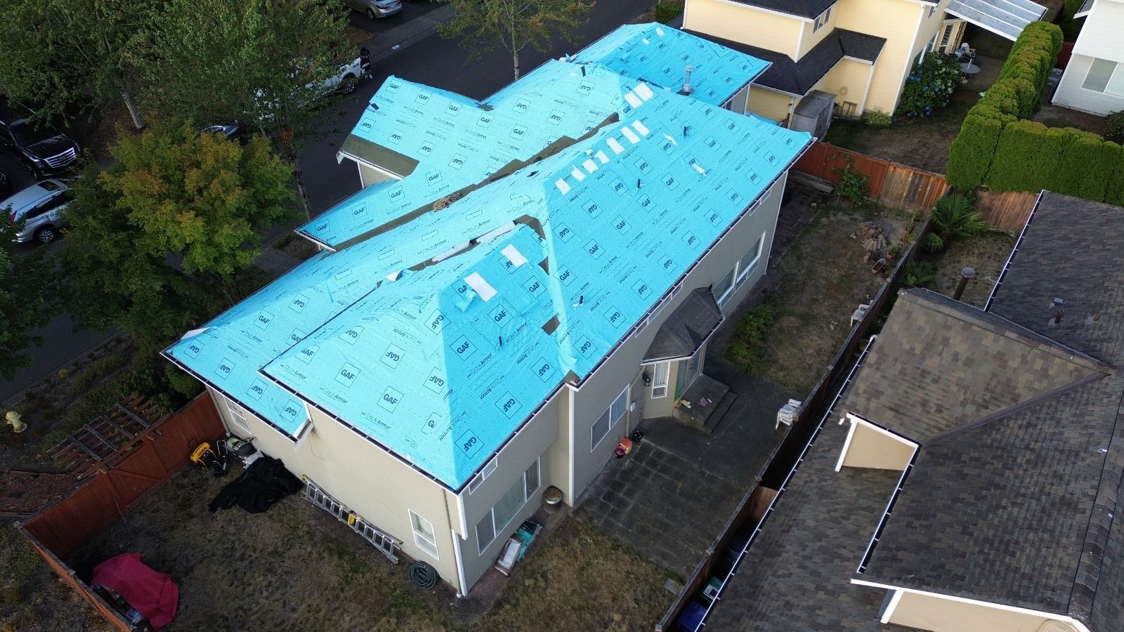 An aerial view of a house with a blue roof.