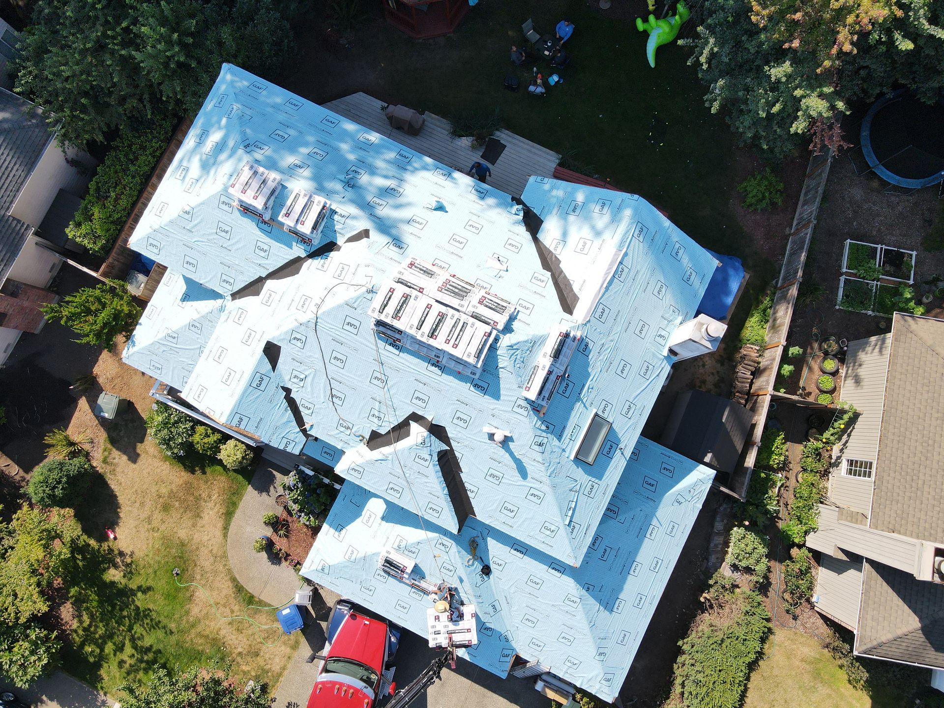 An aerial view of a house with a blue roof