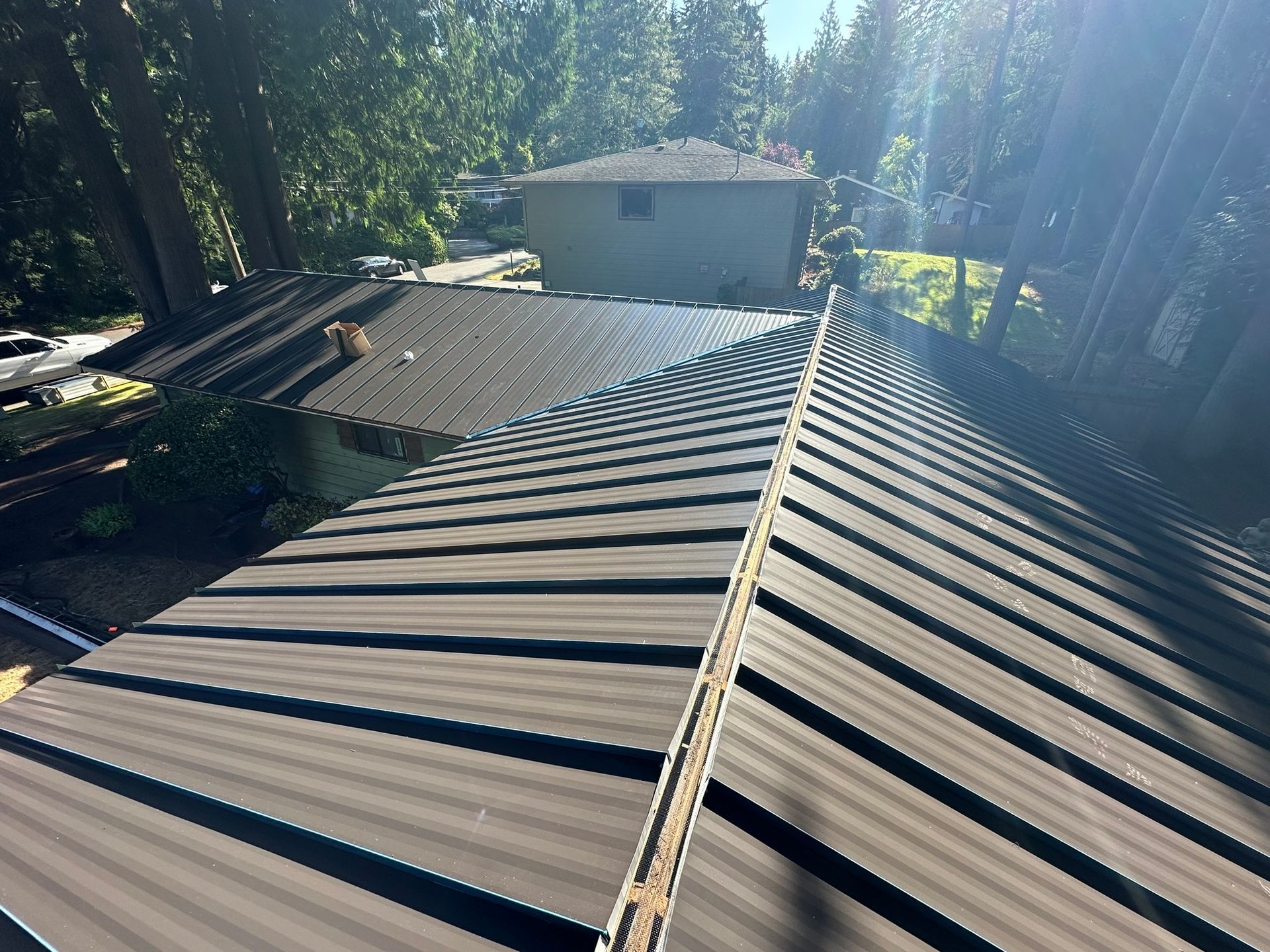 A close up of a roof with a house in the background