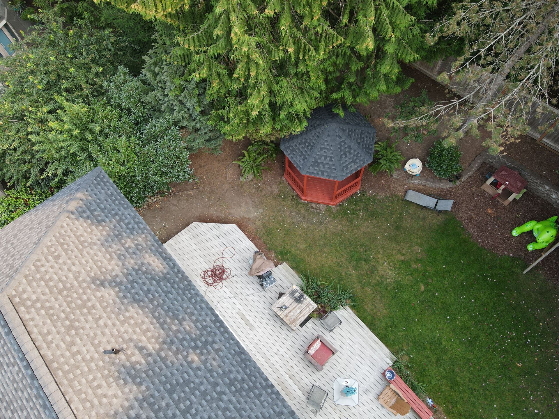 An aerial view of a backyard with a gazebo and patio.