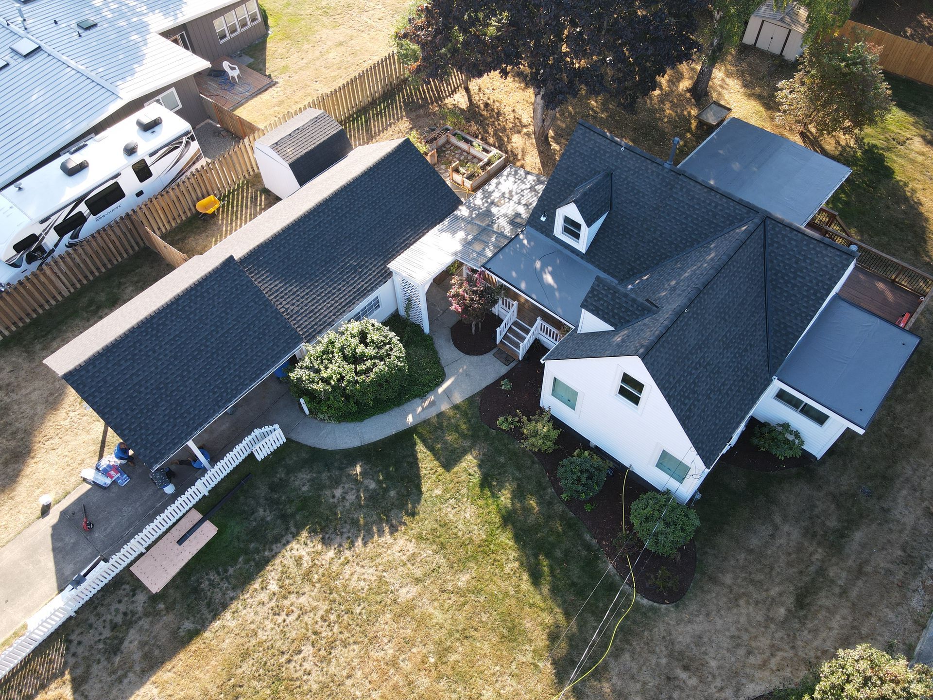 An aerial view of a house with a black roof