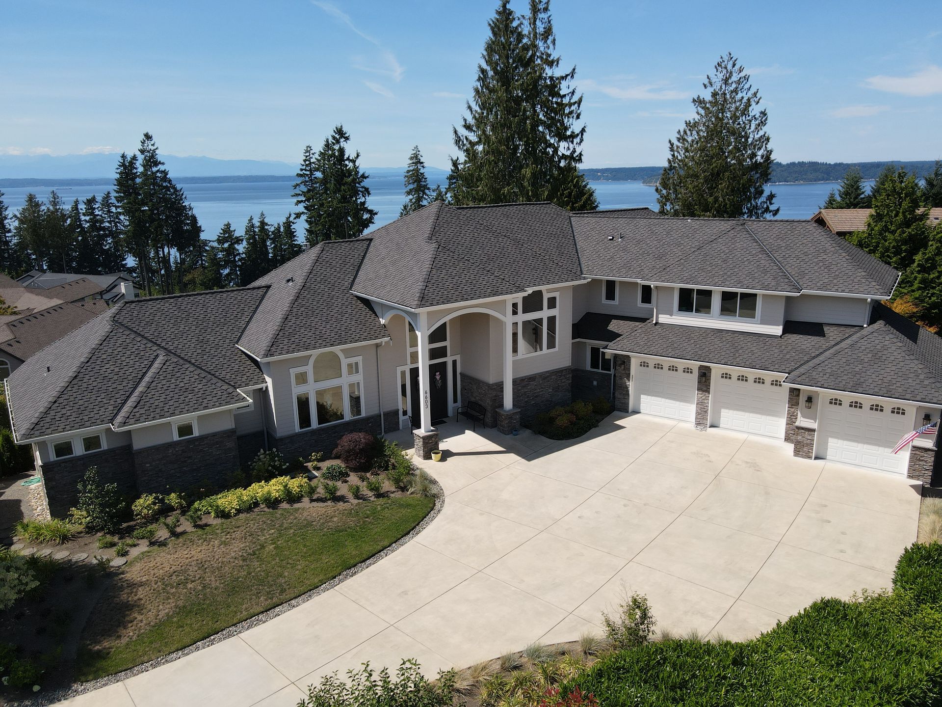 An aerial view of a large house with a large driveway