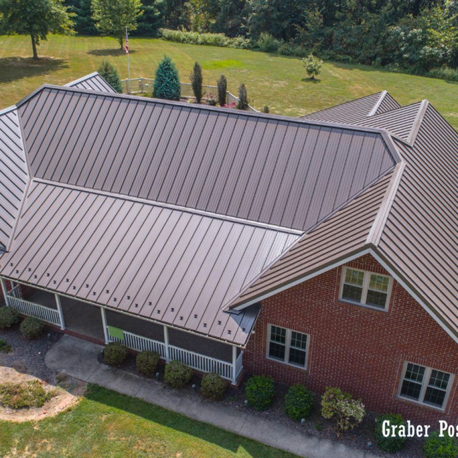 An aerial view of a brick house with a brown roof