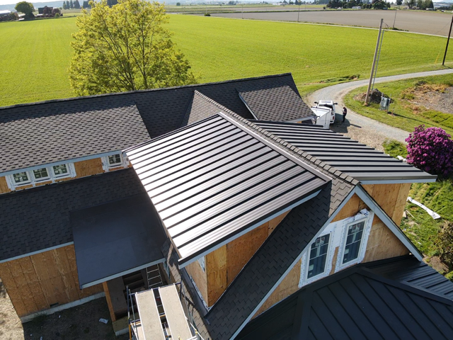 An aerial view of a house with a metal roof
