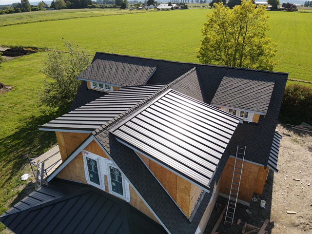 An aerial view of a house with a metal roof