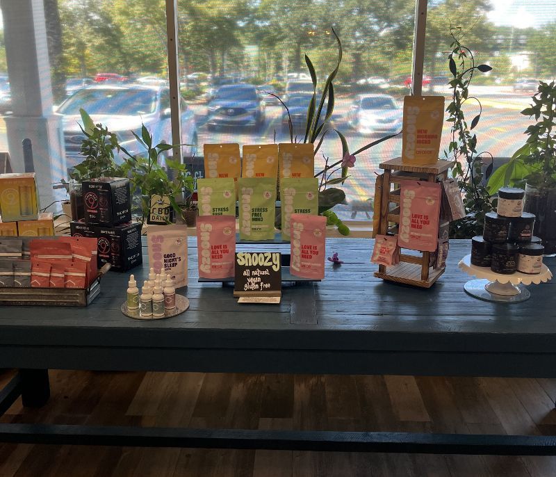 A table with a lot of products on it and a window in the background.
