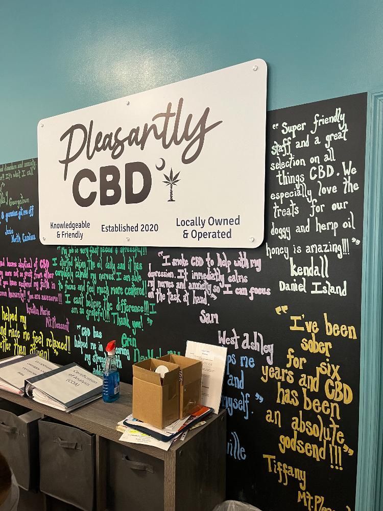 A sign on a wall that says pleasantly cbd