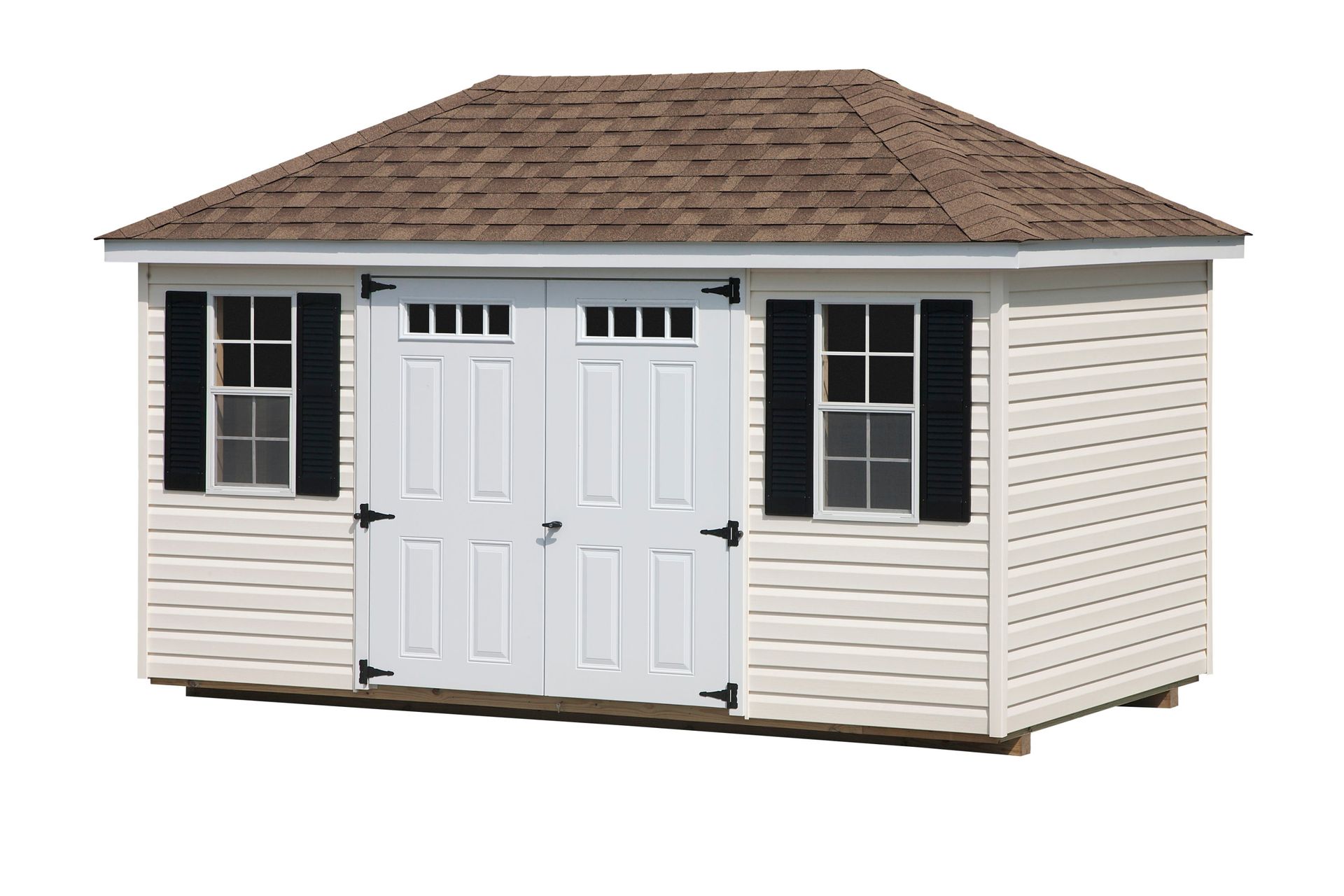 White storage shed with brown roof and black shutters.