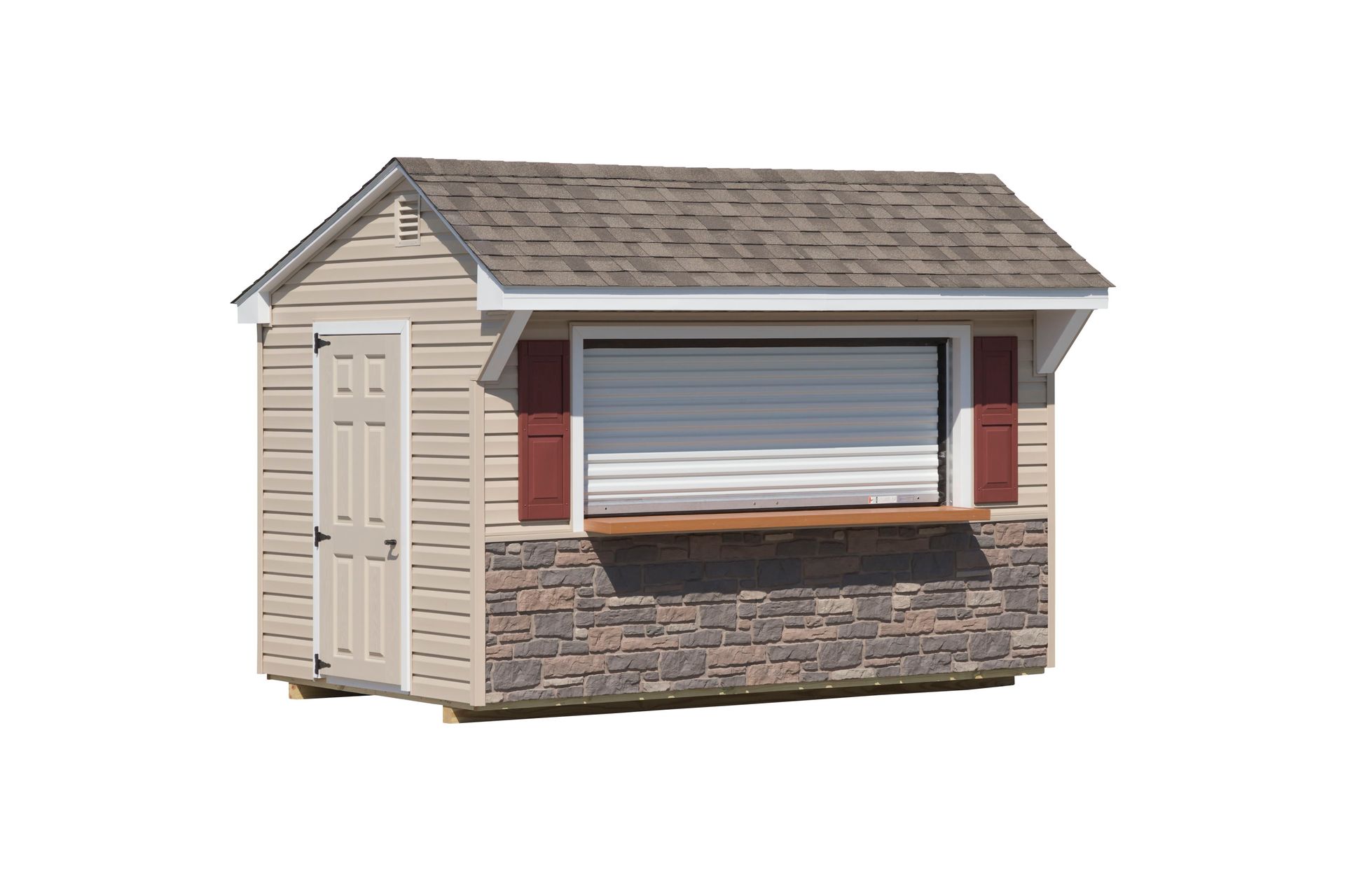 Tan shed with stone facade, counter-height window, roll-up door, red shutters, and shingle roof.