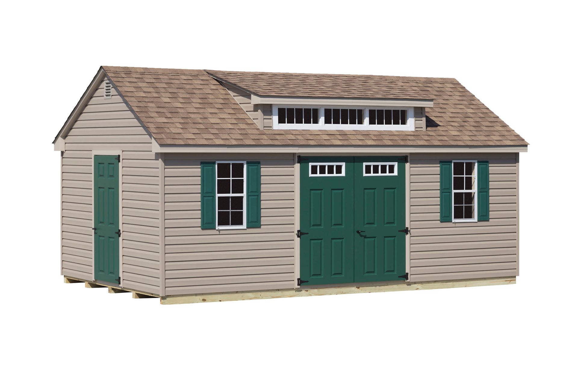 Tan shed with green shutters and doors, brown roof, and small dormer window.