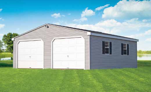 Gray two-car garage with white doors, black shutters, and green lawn under a blue sky.