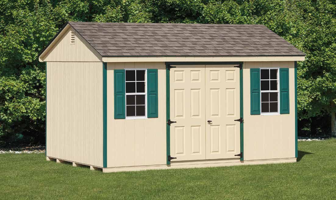 Tan wooden shed with green trim and shutters, two windows, and double doors.