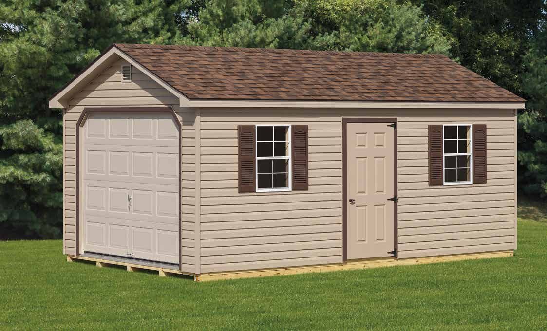 Tan shed with garage door, door, and windows, brown roof, shutters, on green grass.