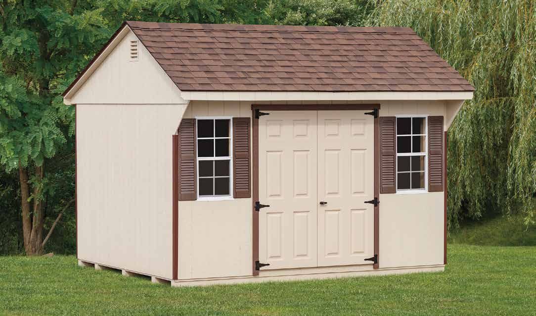 Tan shed with brown roof, double doors, two windows with shutters, on a grassy lawn.