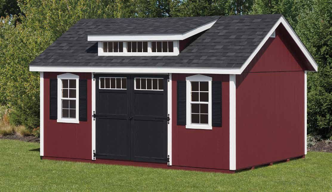 Red shed with white trim, black doors and shutters, and a small dormer window on the roof.