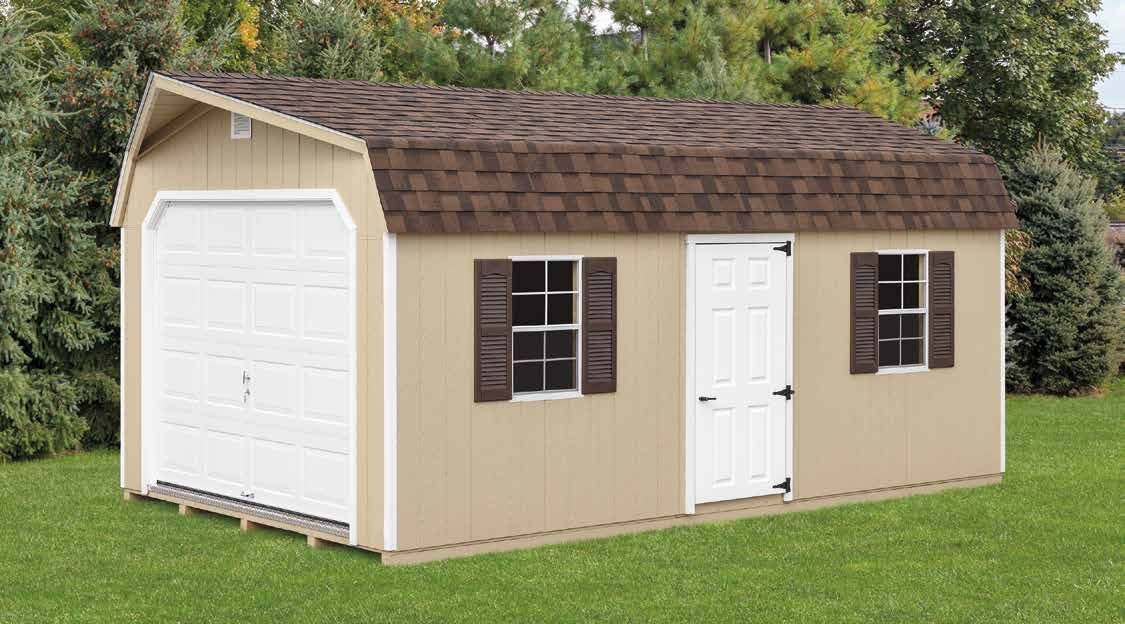 Tan shed with a brown shingled roof, a white garage door, and a white door with brown shutters on a grassy lawn.