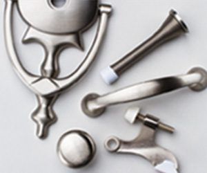 Metal vanity grooming tools and small accessories arranged on a light background