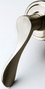 Close-up of a silver door handle on a white door