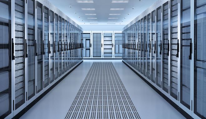 A symmetrical perspective of a modern, brightly lit server room with rows of enclosed computer racks on both sides.