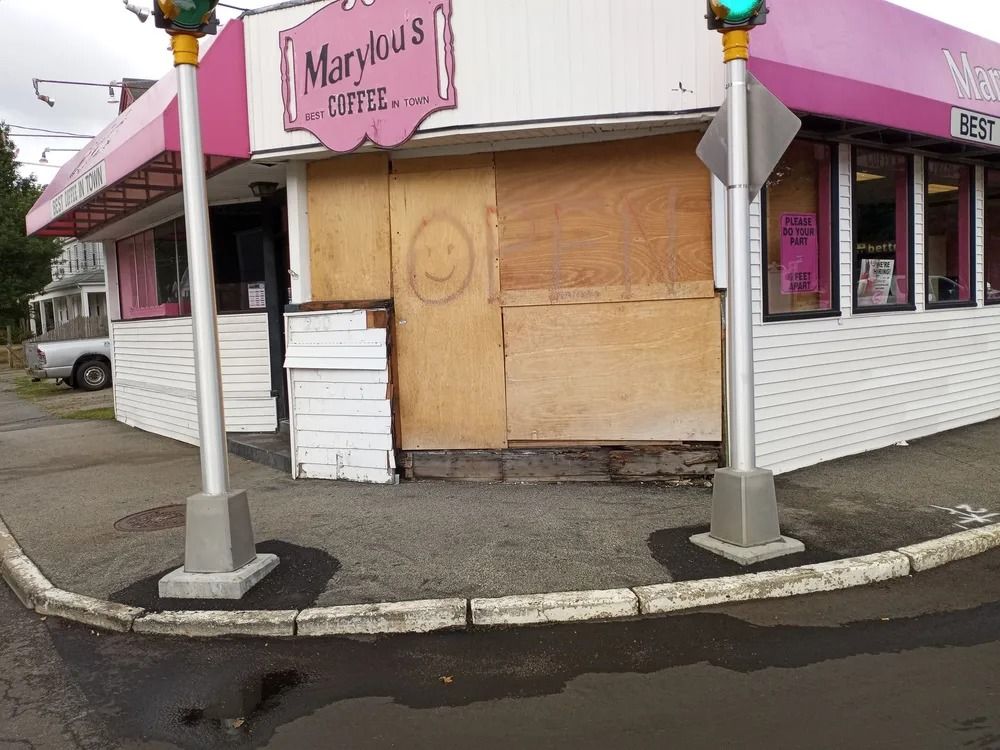 Exterior of a pink and white coffee shop, 