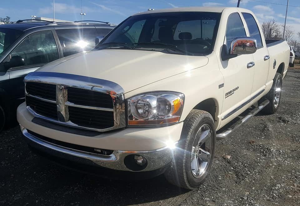 White Dodge Ram pickup truck parked outdoors in a sunny lot