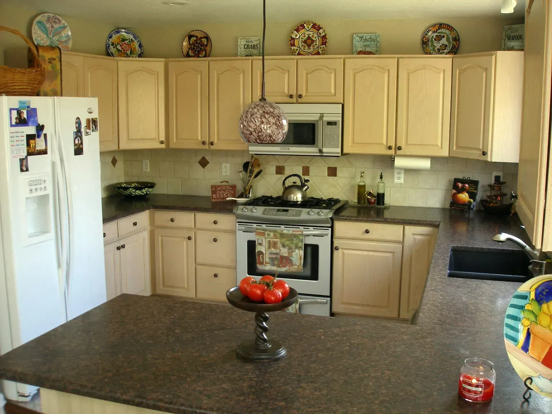 A kitchen with a white refrigerator and a stove top oven