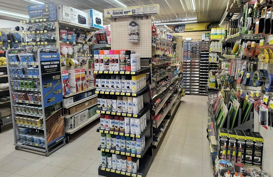 Aisle in a store with shelves of colorful fishing gear and tackle supplies.