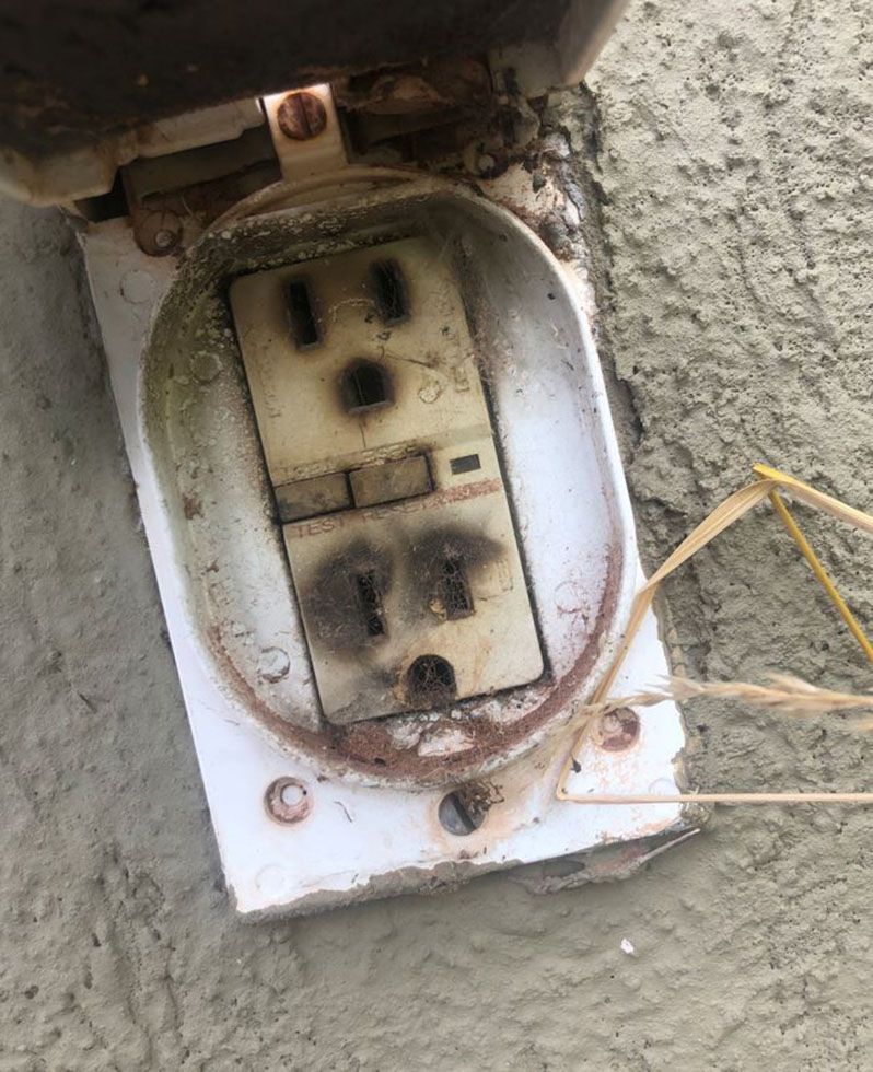 Unsafe burnt electrical outlet