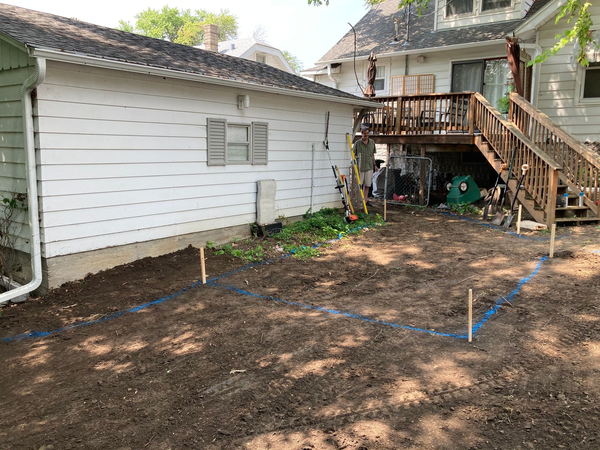 the backyard of a house with a deck and stairs being built