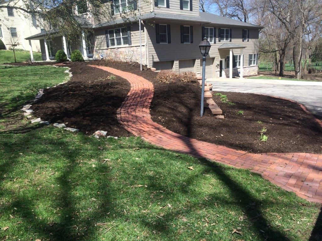 a large house with a brick walkway leading to it