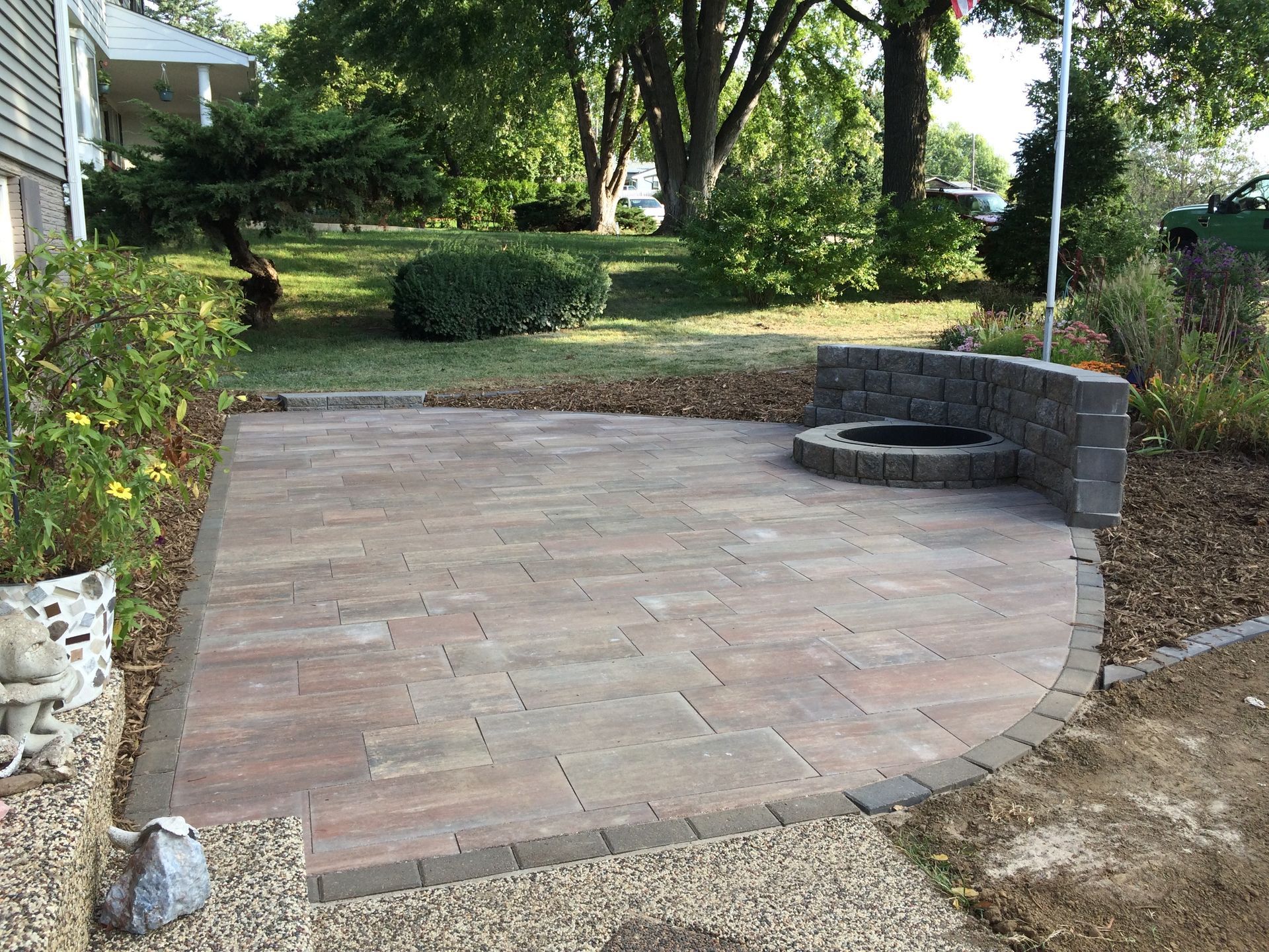 a patio with a fire pit in the middle of it