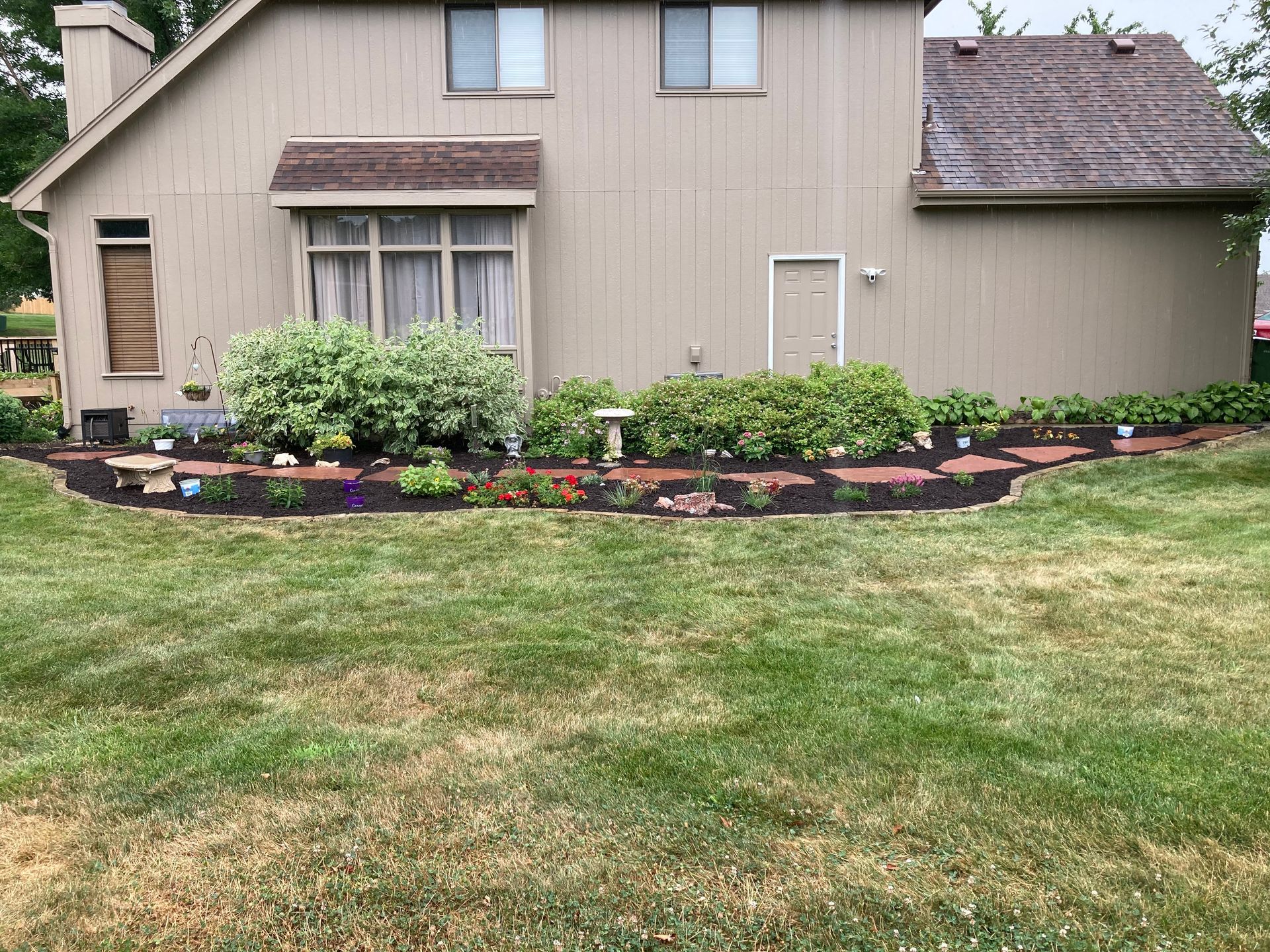 a large house with a lush green lawn in front of it