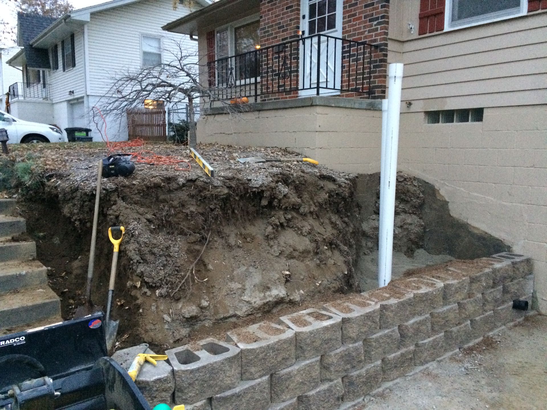 a brick wall is being built in front of a house