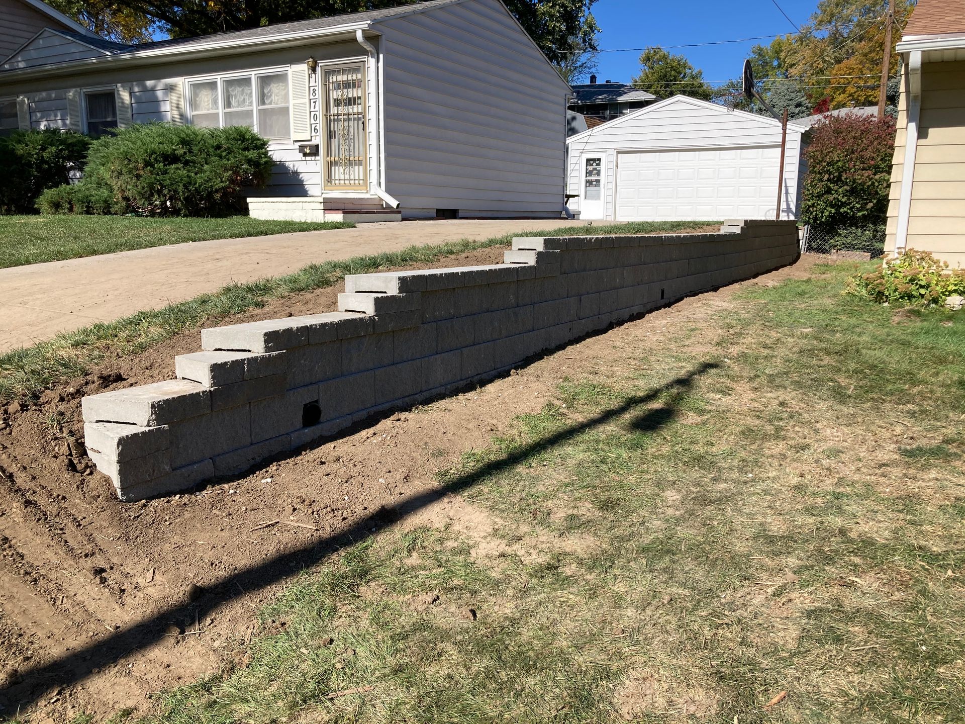 a brick wall is being built in front of a house