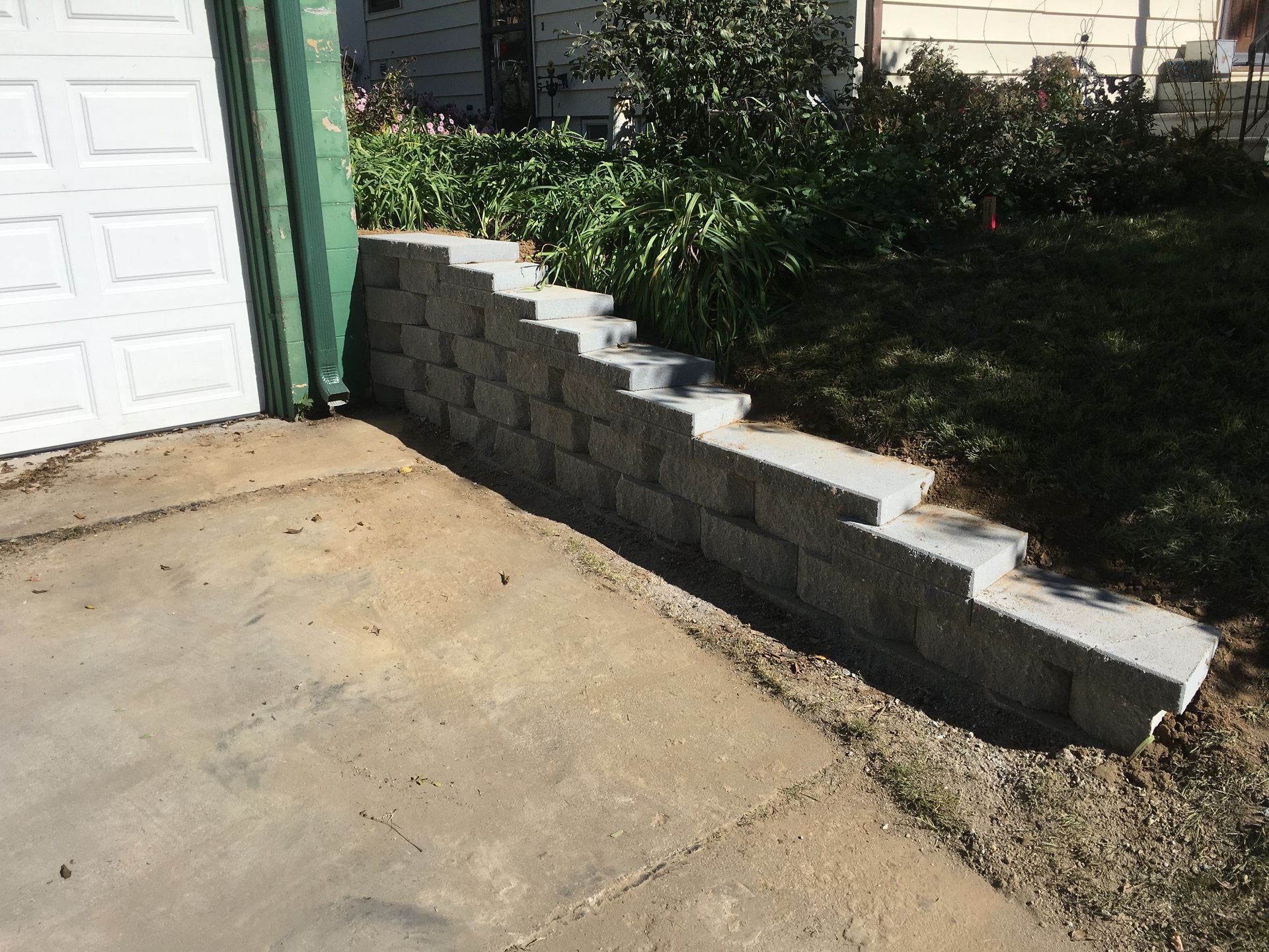 a brick wall is being built in front of a garage door