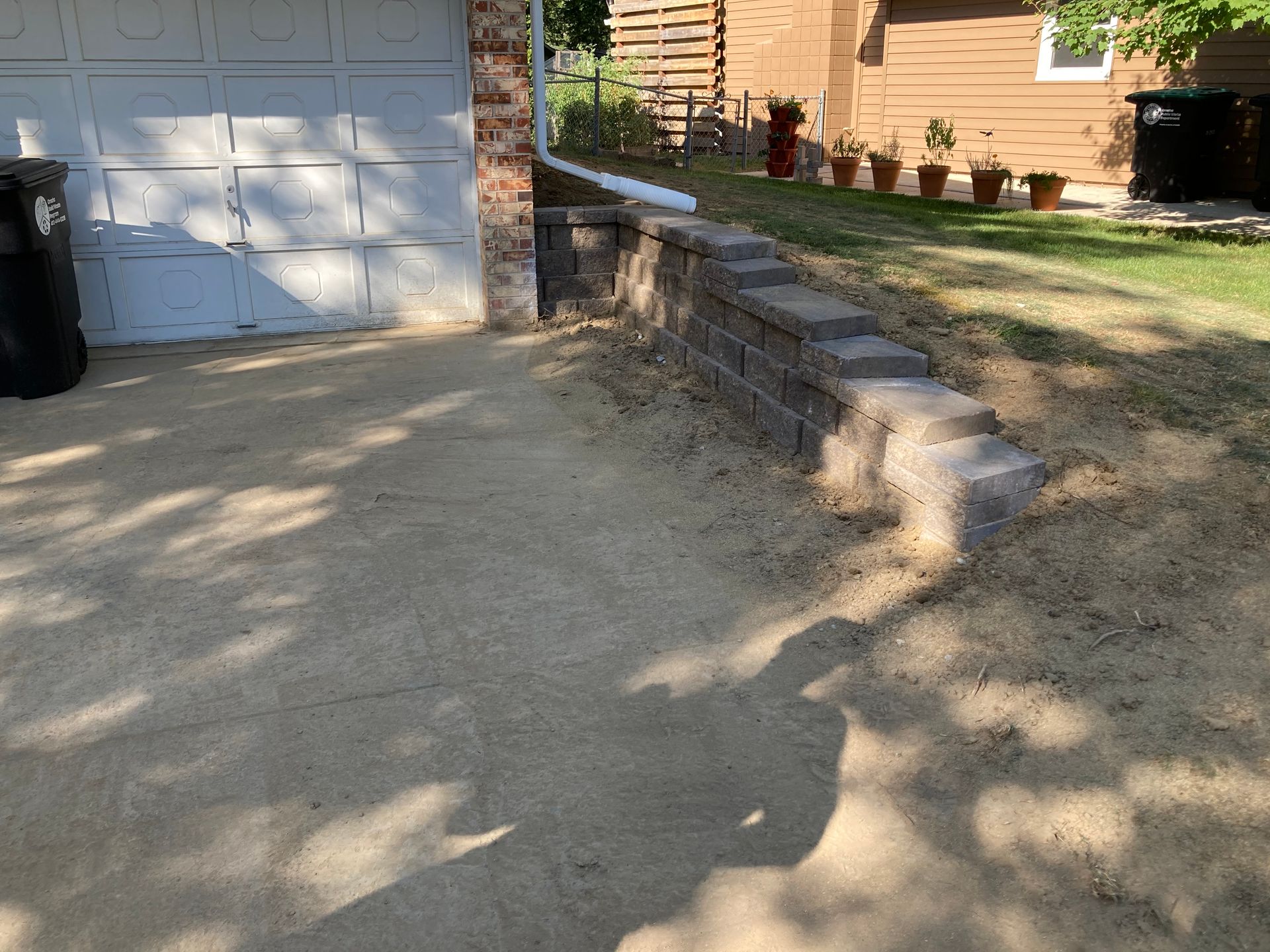 a brick wall is being built in front of a garage