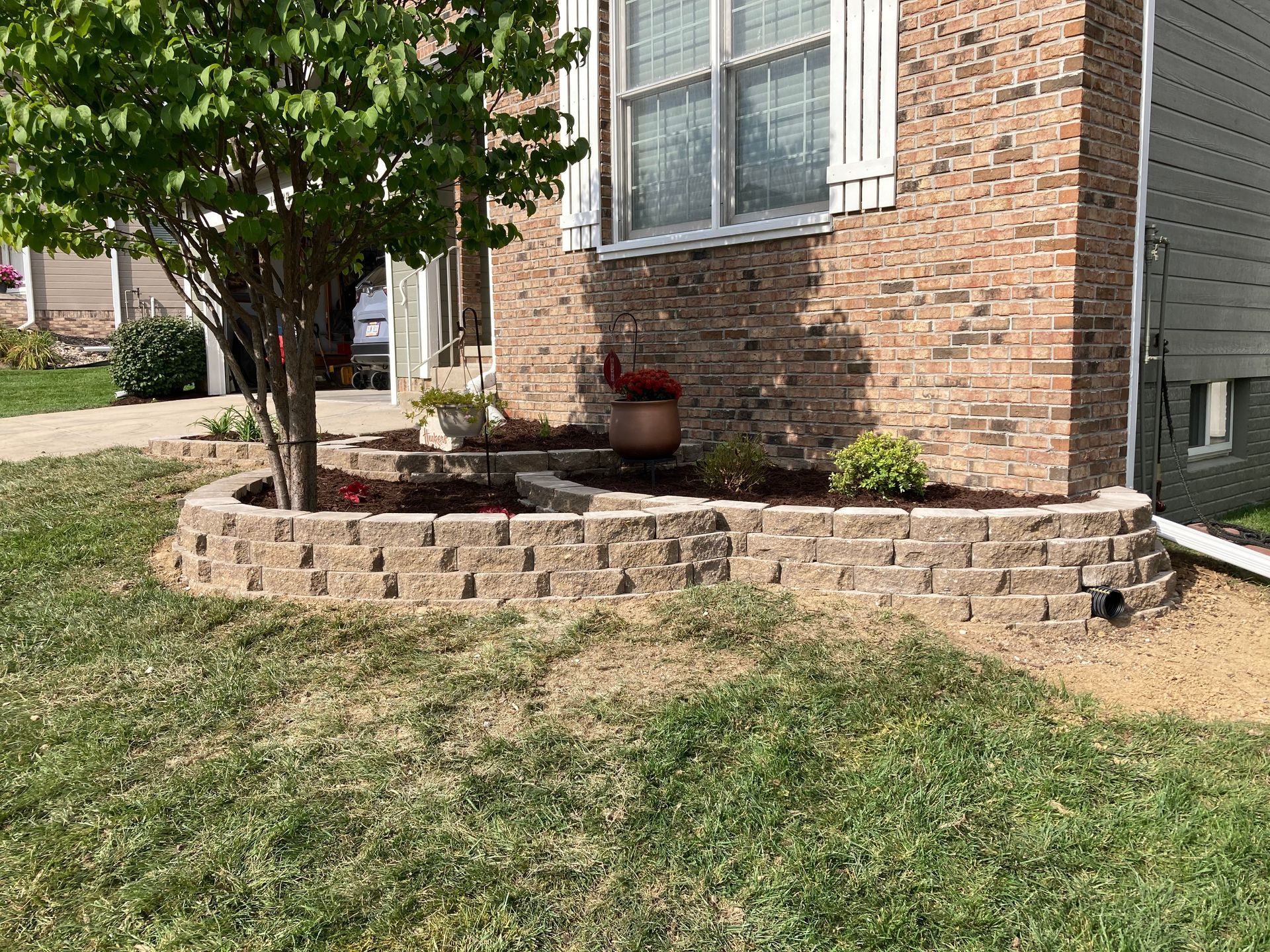 a brick house with a planter in front of it