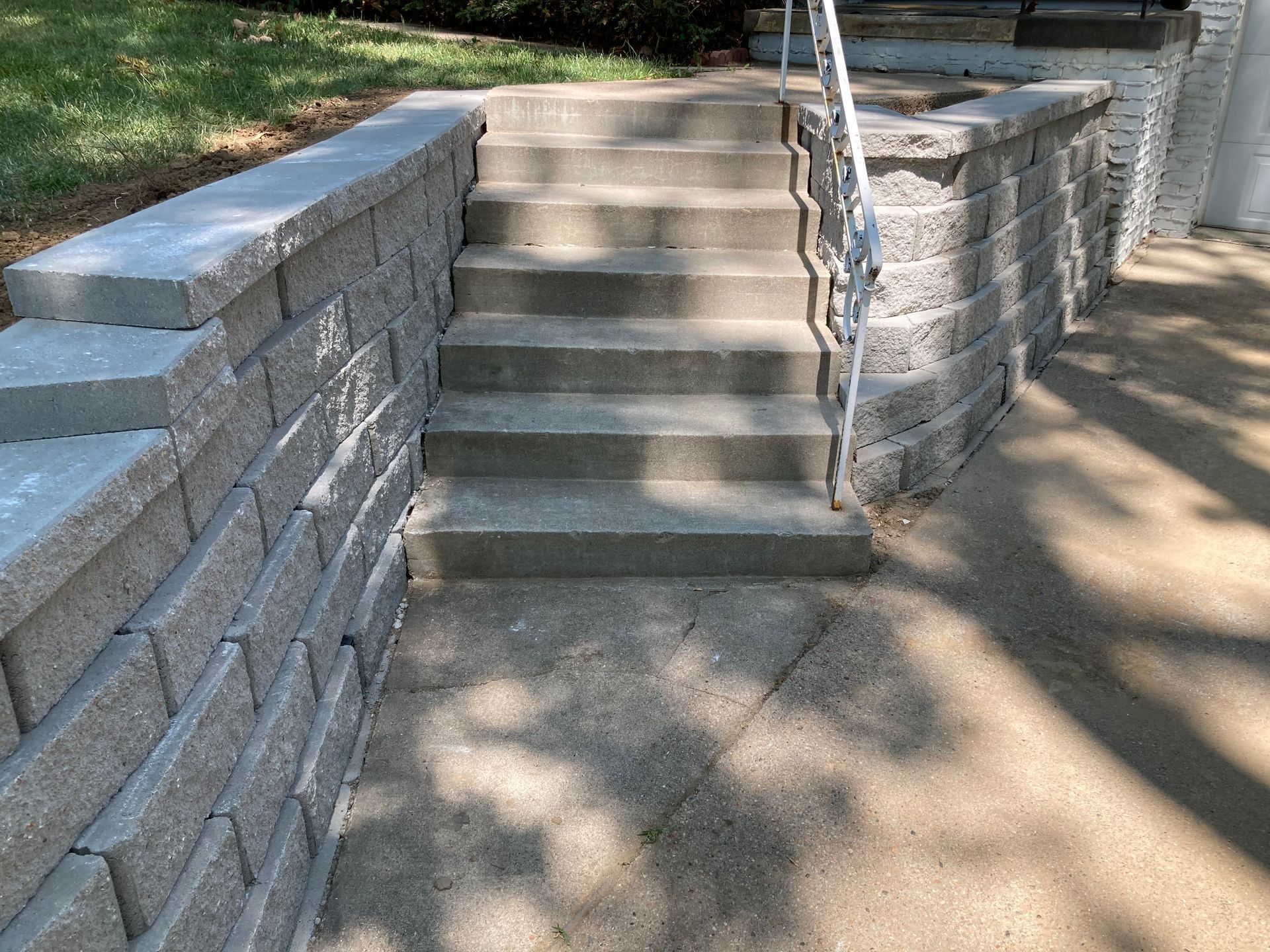 a set of stairs leading up to a brick wall