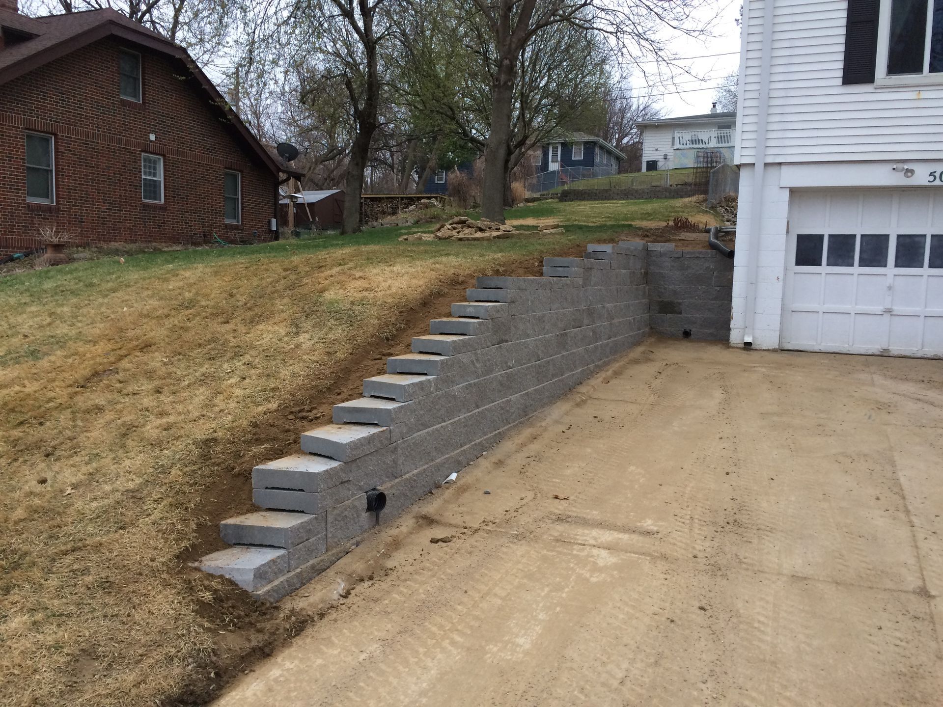 a brick wall is being built in front of a house