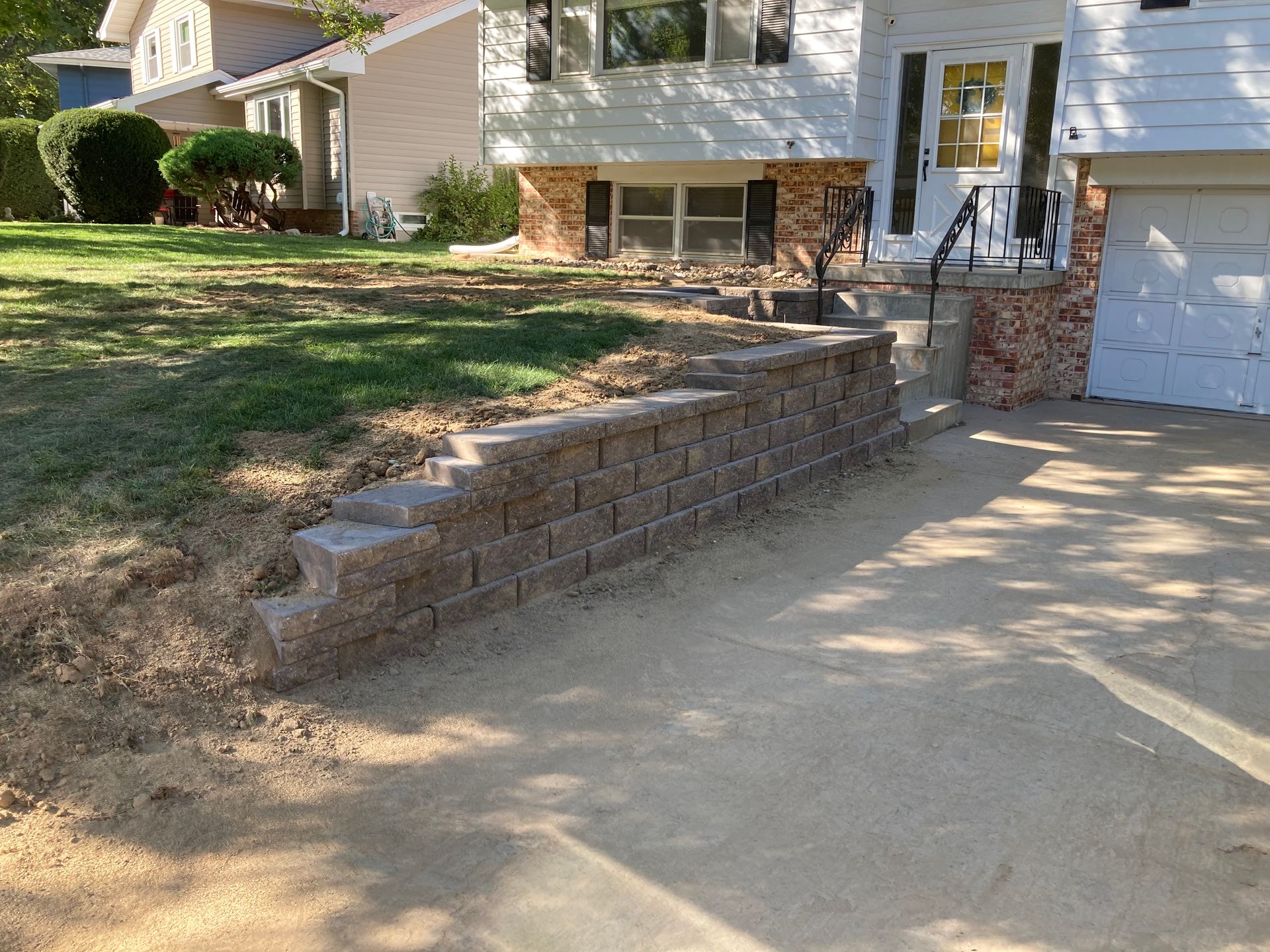 a brick wall is being built in front of a house